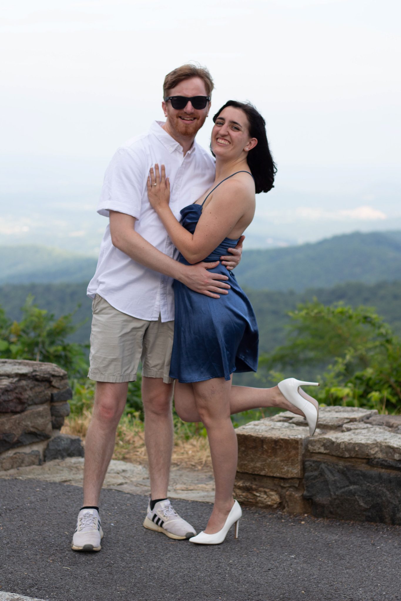 Couple smiling together at a scenic mountain overlook
