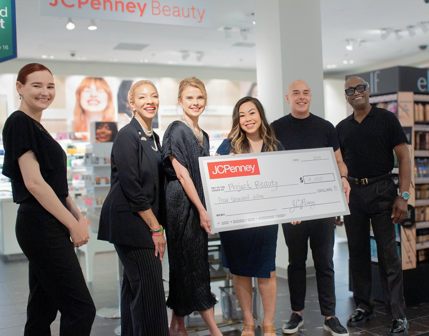 Community team presenting a large donation check at an event