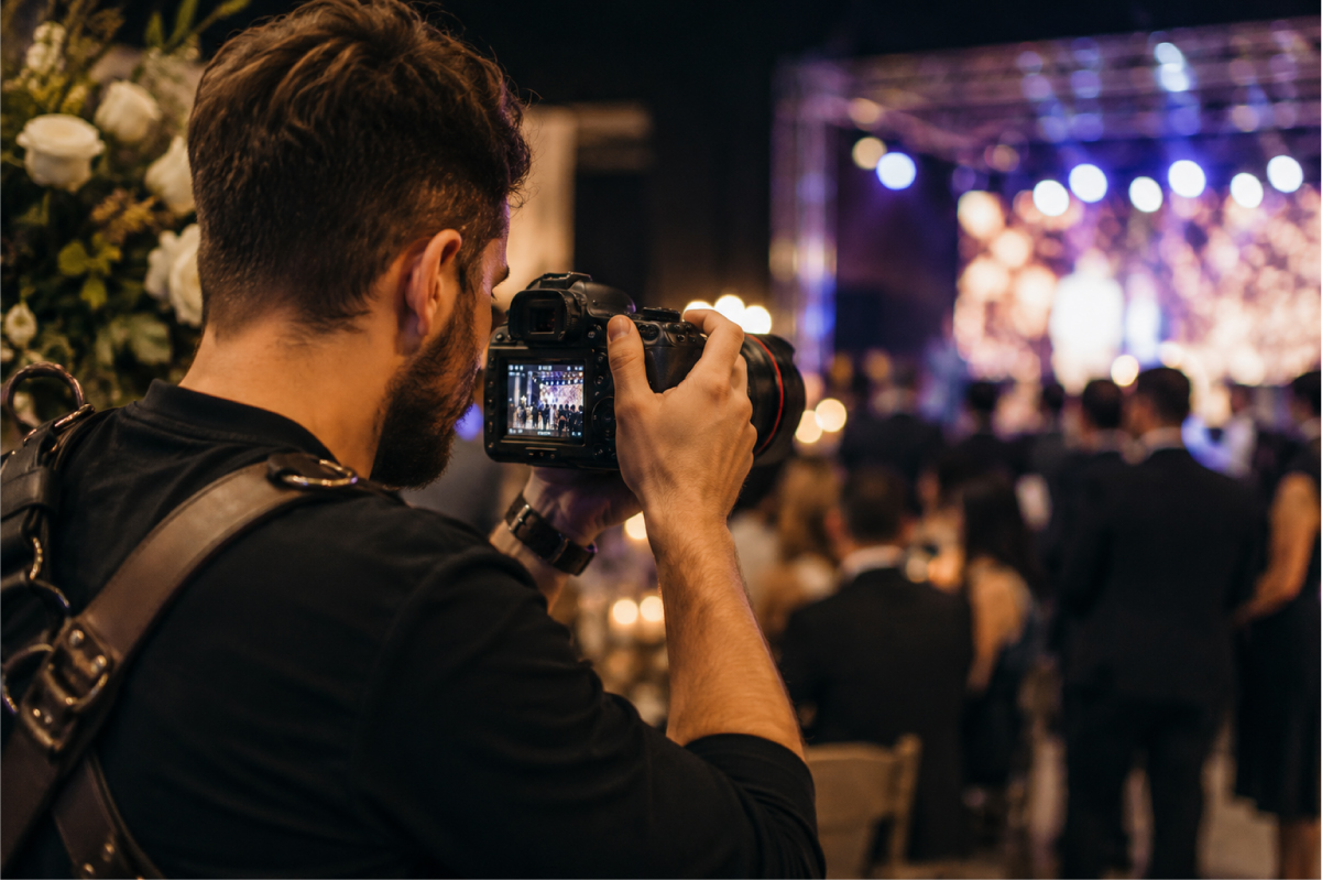 Photographer documenting a live event from within the crowd