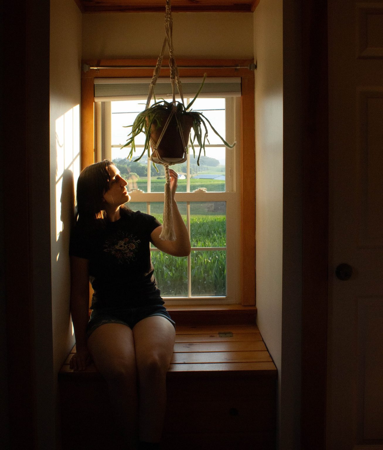 Woman beside a window in a quiet interior